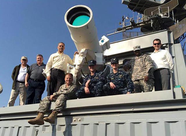 People sitting around telescope on observatory deck